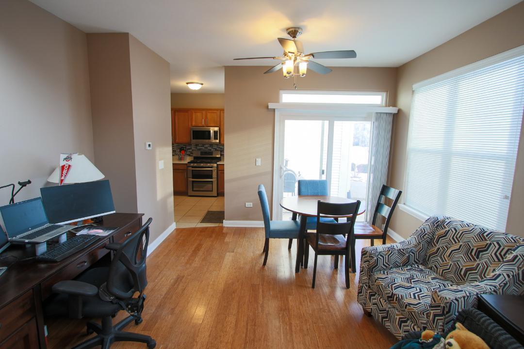 2136 Sunrise Circle Aurora, IL 60503 - Photo 7 of 21 a view of a dining room with furniture and wooden floor