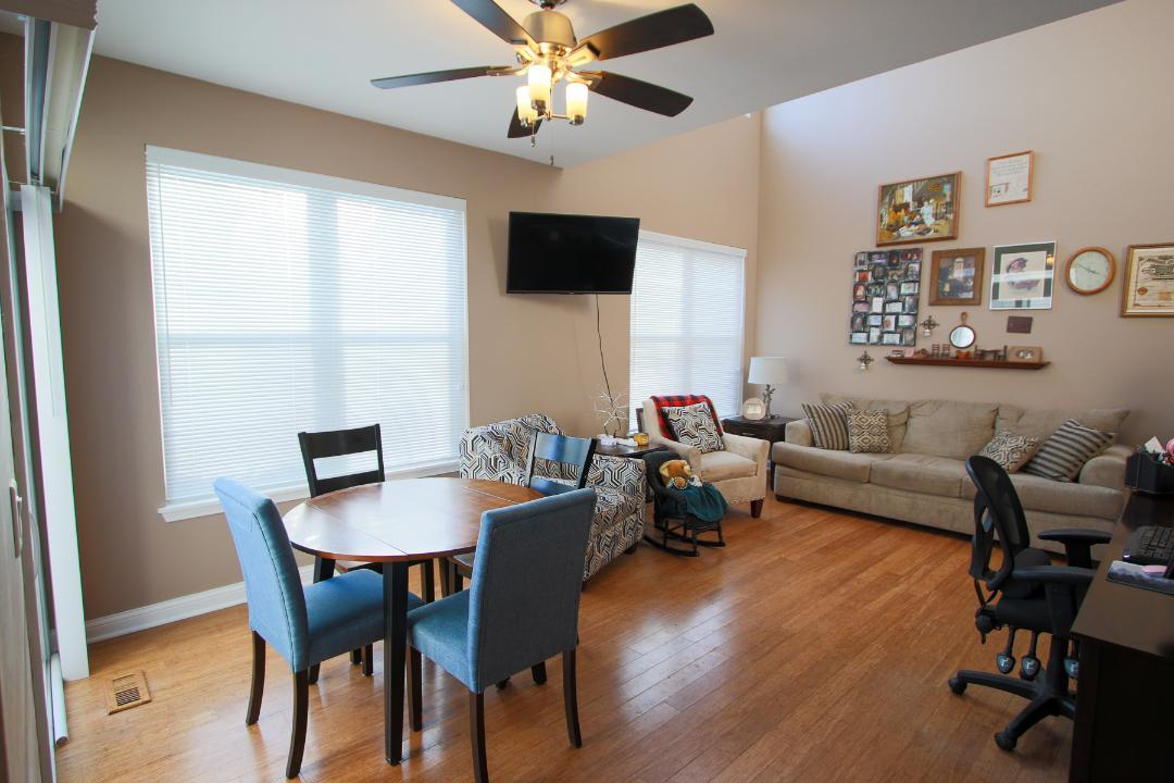 2136 Sunrise Circle Aurora, IL 60503 - Photo 8 of 21 a living room with furniture a flat screen tv and a window