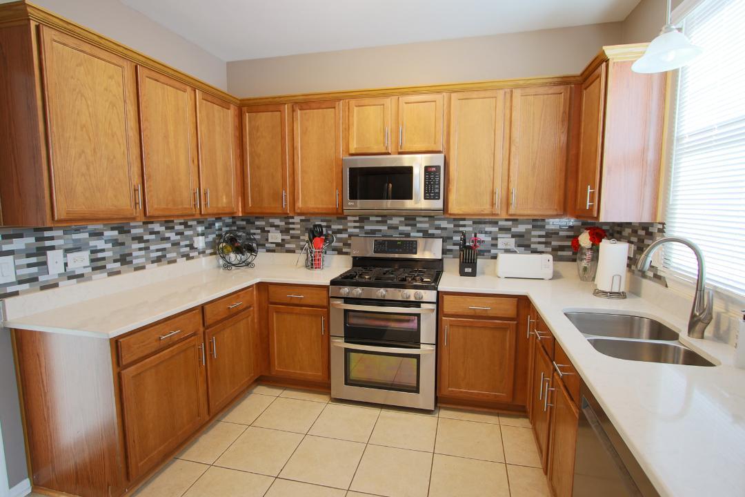 2136 Sunrise Circle Aurora, IL 60503 - Photo 9 of 21 a kitchen with a sink stove and cabinets