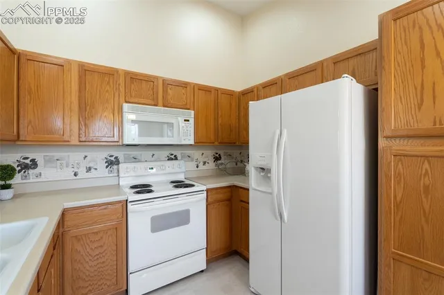 a kitchen with a white stove top oven and sink