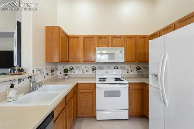 a kitchen with a sink stove and refrigerator