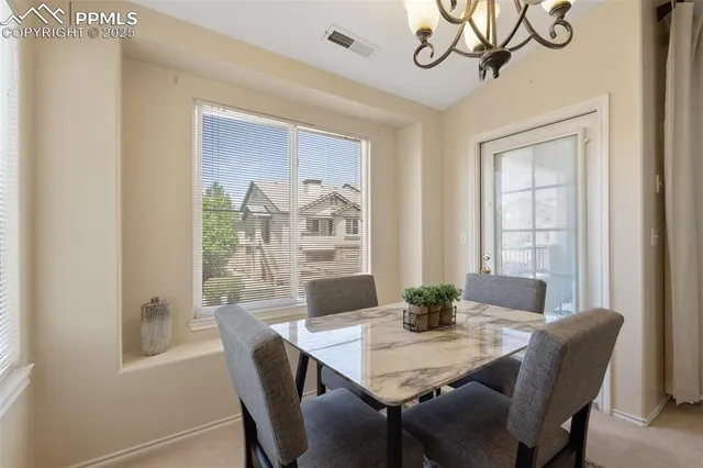 a view of a dining room with furniture window and outside view