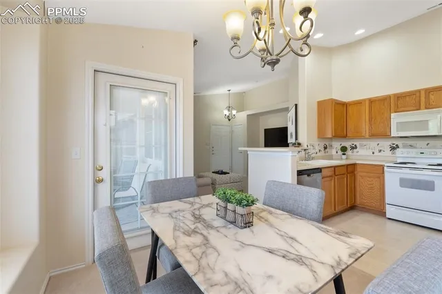 a kitchen with a table chairs stove and microwave