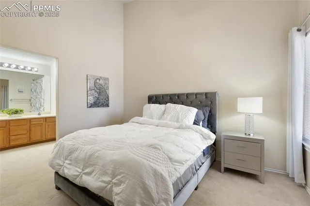 a bedroom with a bed and a potted plant