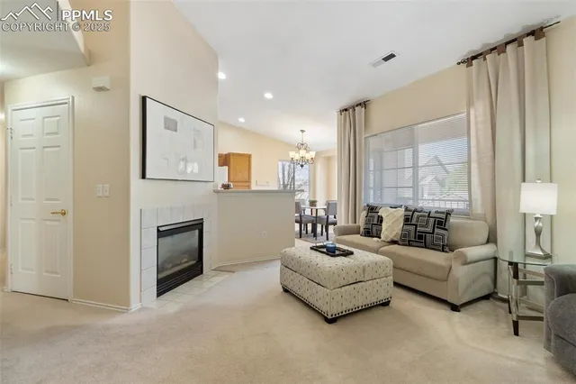 a spacious bedroom with furniture and a fireplace