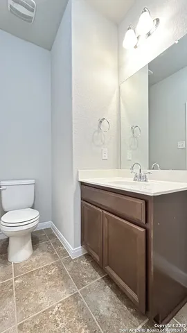 a bathroom with a sink a toilet and mirror