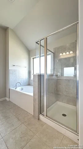 a bathroom with a bathtub and a shower