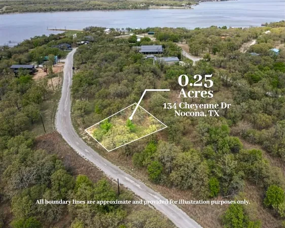 an aerial view of a house with a yard and lake view