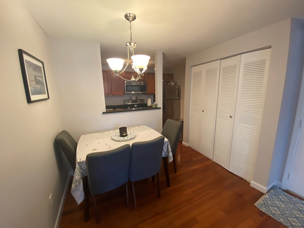 200 Manning Street, Unit 2B Hudson, MA 01749 - Photo 3 of 9 a view of a dining room with furniture and wooden floor