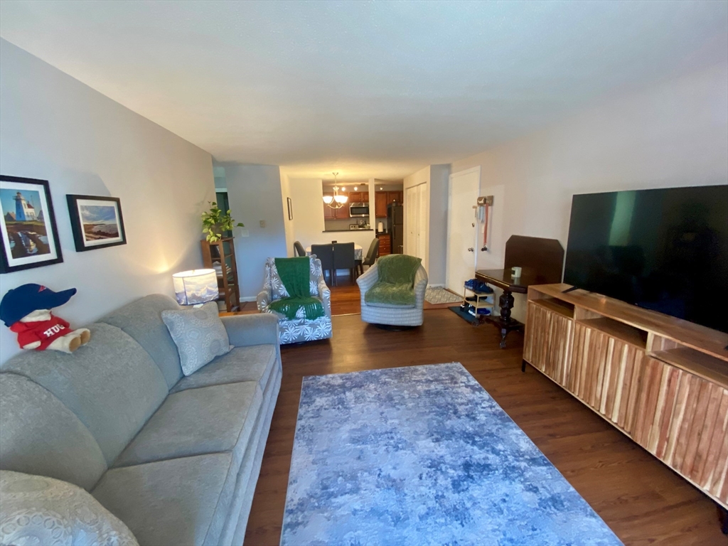 200 Manning Street, Unit 2B Hudson, MA 01749 - Photo 4 of 9 a living room with furniture and a flat screen tv