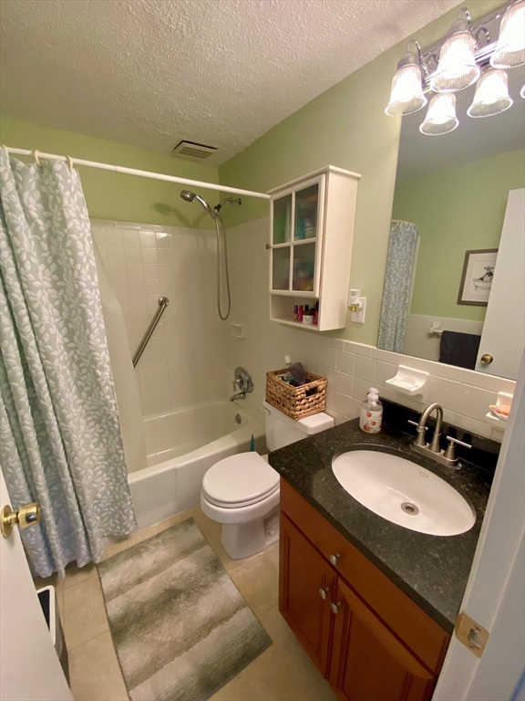 200 Manning Street, Unit 2B Hudson, MA 01749 - Photo 9 of 9 a bathroom with a sink toilet a mirror and shower