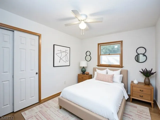 a bedroom with a large bed and a chandelier