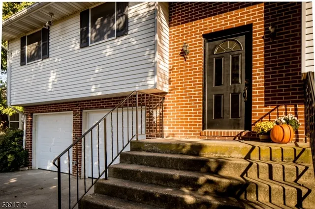 a view of a house with a small wooden fence and a window