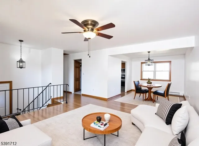 a living room with furniture a rug and a chandelier