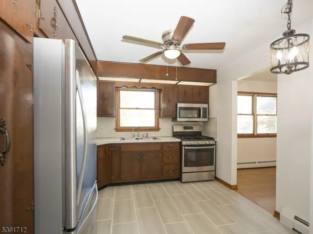 a kitchen with stainless steel appliances granite countertop a stove and a refrigerator