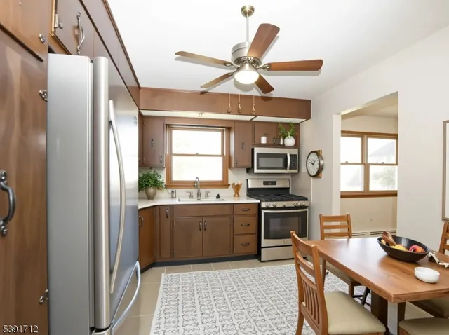 a kitchen with a stove a refrigerator and a sink