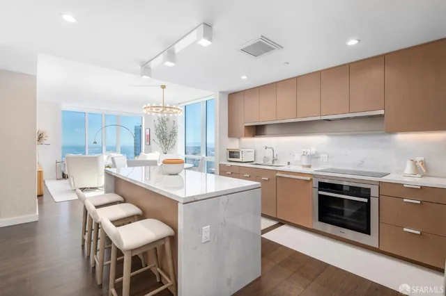 a kitchen with a sink cabinets and wooden floor