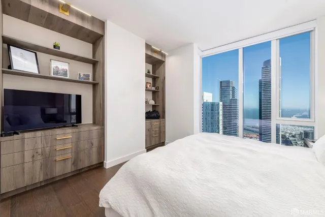 a bedroom with a bed and a flat screen tv