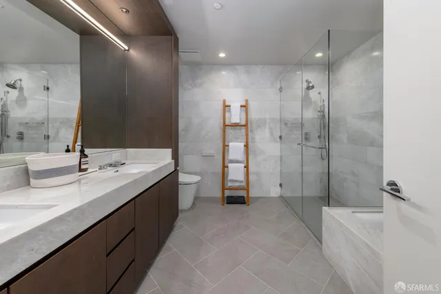 a bathroom with a double vanity sink mirror double and shower
