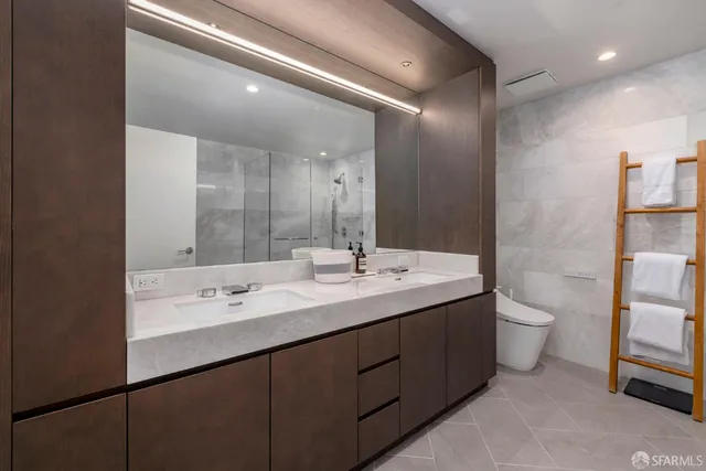 a bathroom with a double vanity sink and a mirror