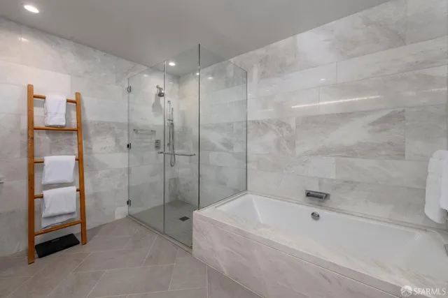 a bathroom with a bathtub and a shower
