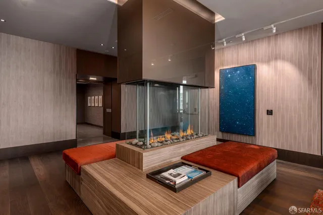 a living room with hard wood floor and furniture