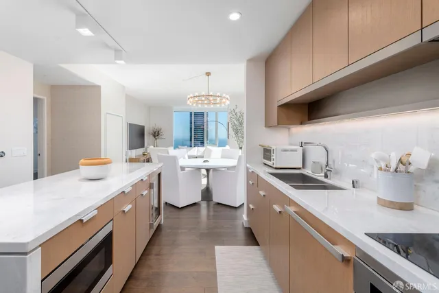 a kitchen with sink stove and cabinets