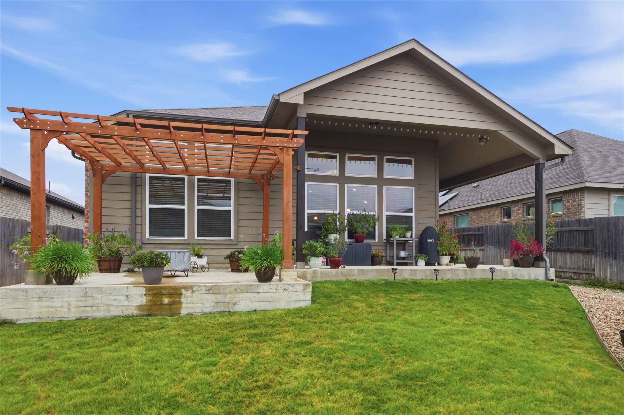 147 Brazil Drive Buda, TX 78610 - Photo 1 of 1 a front view of a house with a yard table and chairs