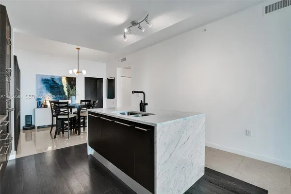 a large kitchen with a table and chairs