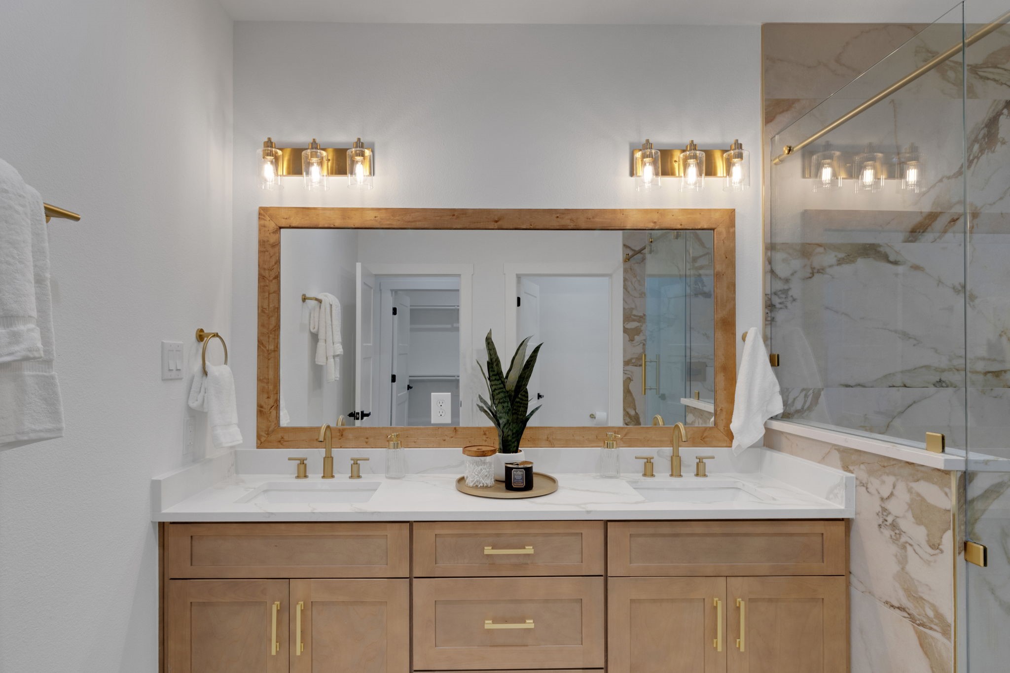 4202 Plaag Street Houston, TX 77016 - Photo 26 of 38 Luxurious primary bath with dual vanity, quartz counters, and gold accents for a spa-like feel.