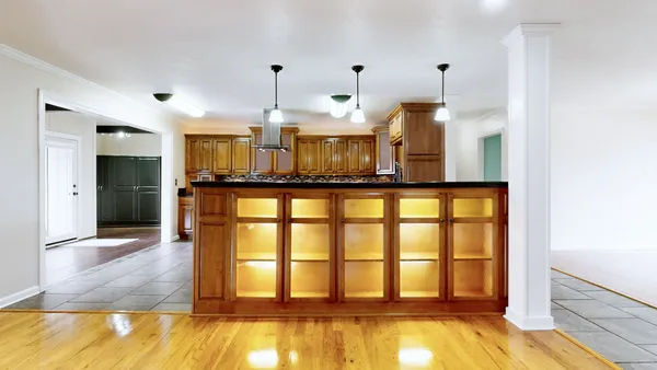 a view of a livingroom with wooden floor and a fireplace
