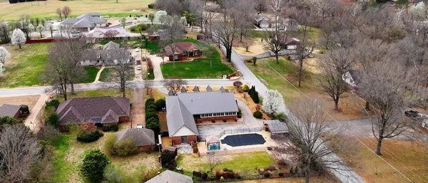 an aerial view of house with yard swimming pool and outdoor seating