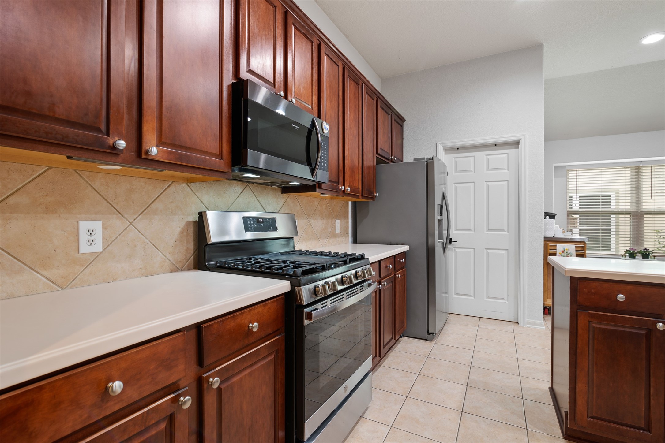19306 Young Oak Street Spring, TX 77379 - Photo 11 of 28 The kitchen also features under cabinet lighting, matching SS appliances to include a gas range installed in 2022.