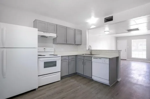 a kitchen with a white cabinets and white appliances