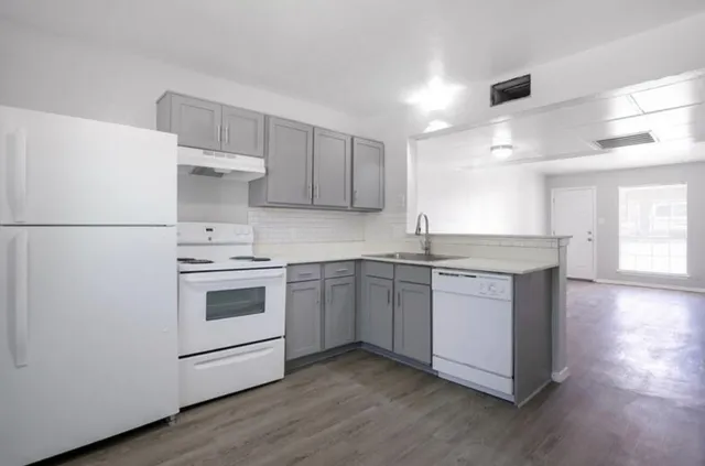 a kitchen with a white cabinets and white appliances