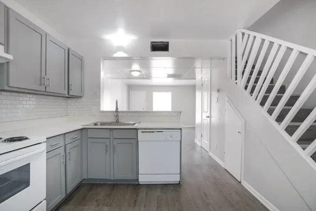 a kitchen with a sink stove and cabinets