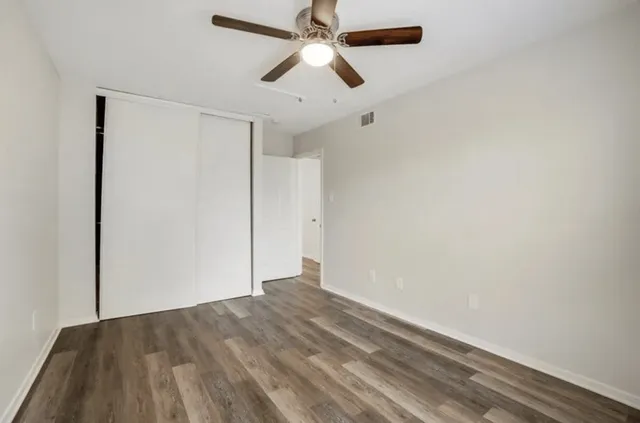 a view of empty room with ceiling fan