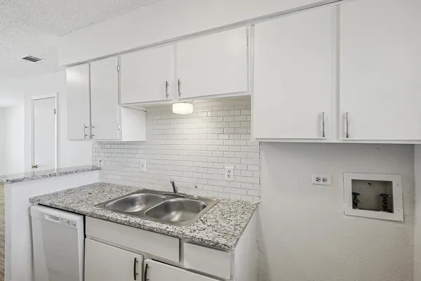 a kitchen with a sink and cabinets