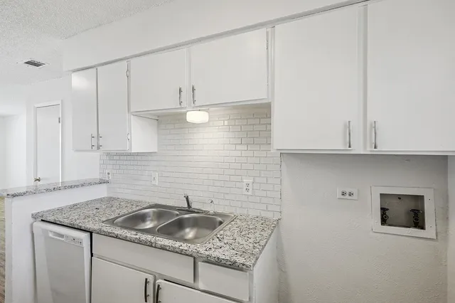 a kitchen with a sink and cabinets