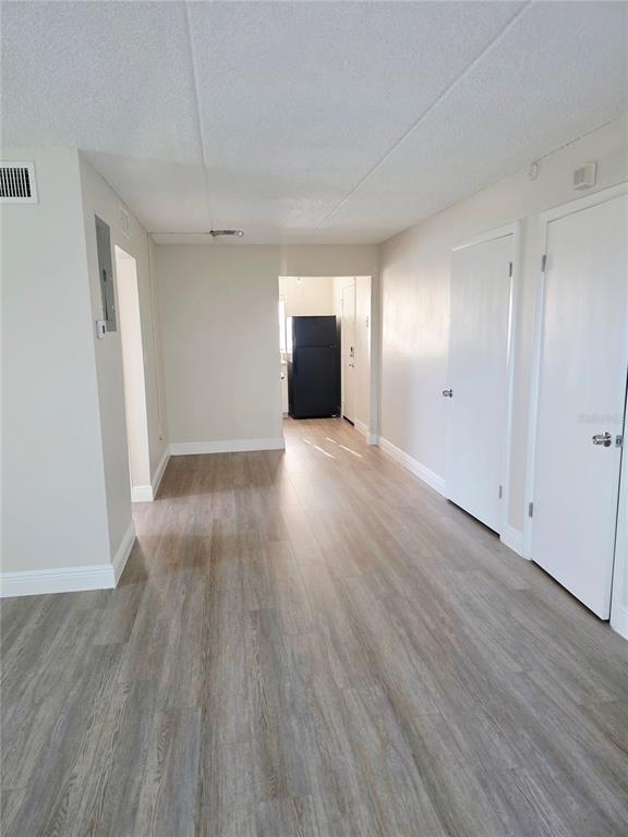525 South Conway Road, Unit 53 Orlando, FL 32807 - Photo 5 of 12 a view of empty room with wooden floor