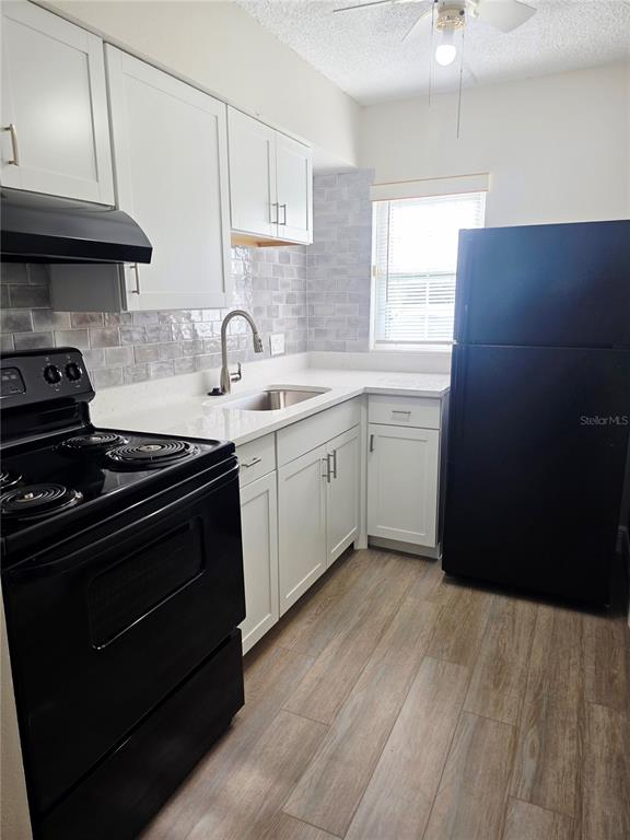 525 South Conway Road, Unit 53 Orlando, FL 32807 - Photo 6 of 12 a kitchen with a sink stove and cabinets