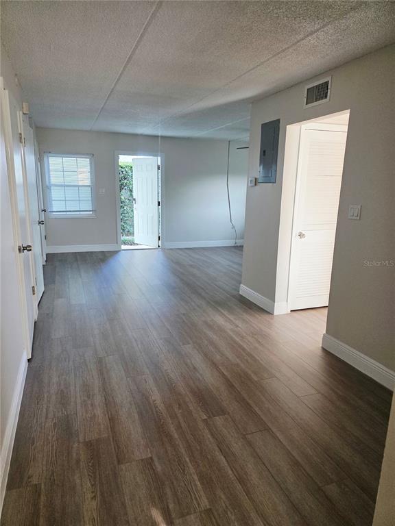 525 South Conway Road, Unit 53 Orlando, FL 32807 - Photo 8 of 12 an empty room with wooden floor and windows