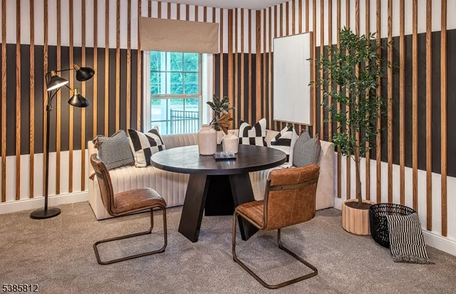 a dining room with furniture and a window