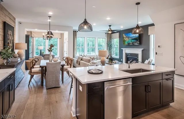 a kitchen with a sink a counter space dining table and chairs