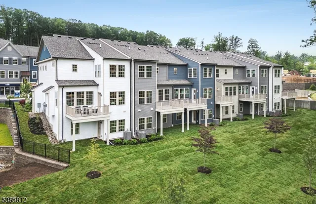 a aerial view of large residential houses with yard and trees