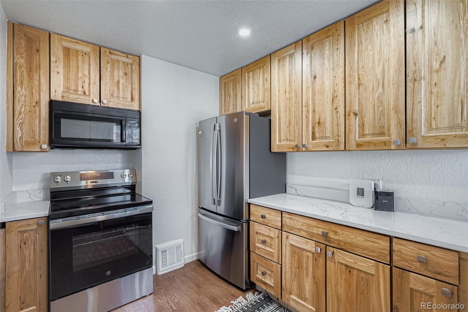 680 Irving Street Denver, CO 80204 - Photo 13 of 33 a kitchen with stainless steel appliances a stove sink and microwave