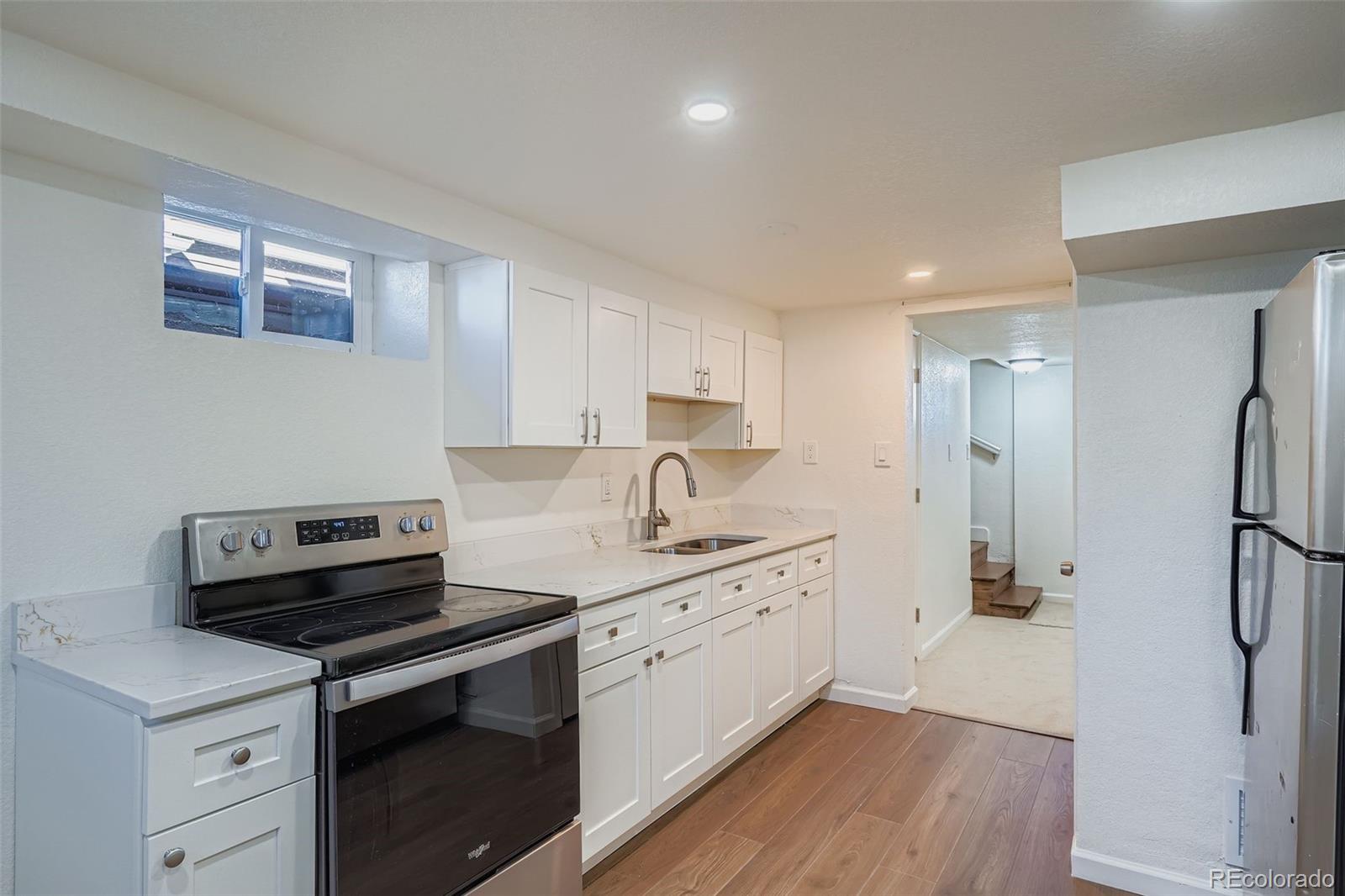 680 Irving Street Denver, CO 80204 - Photo 22 of 33 a kitchen with a stove and a refrigerator