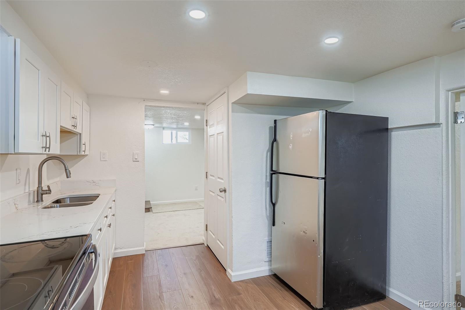 680 Irving Street Denver, CO 80204 - Photo 23 of 33 a bathroom with a sink a mirror and a shower