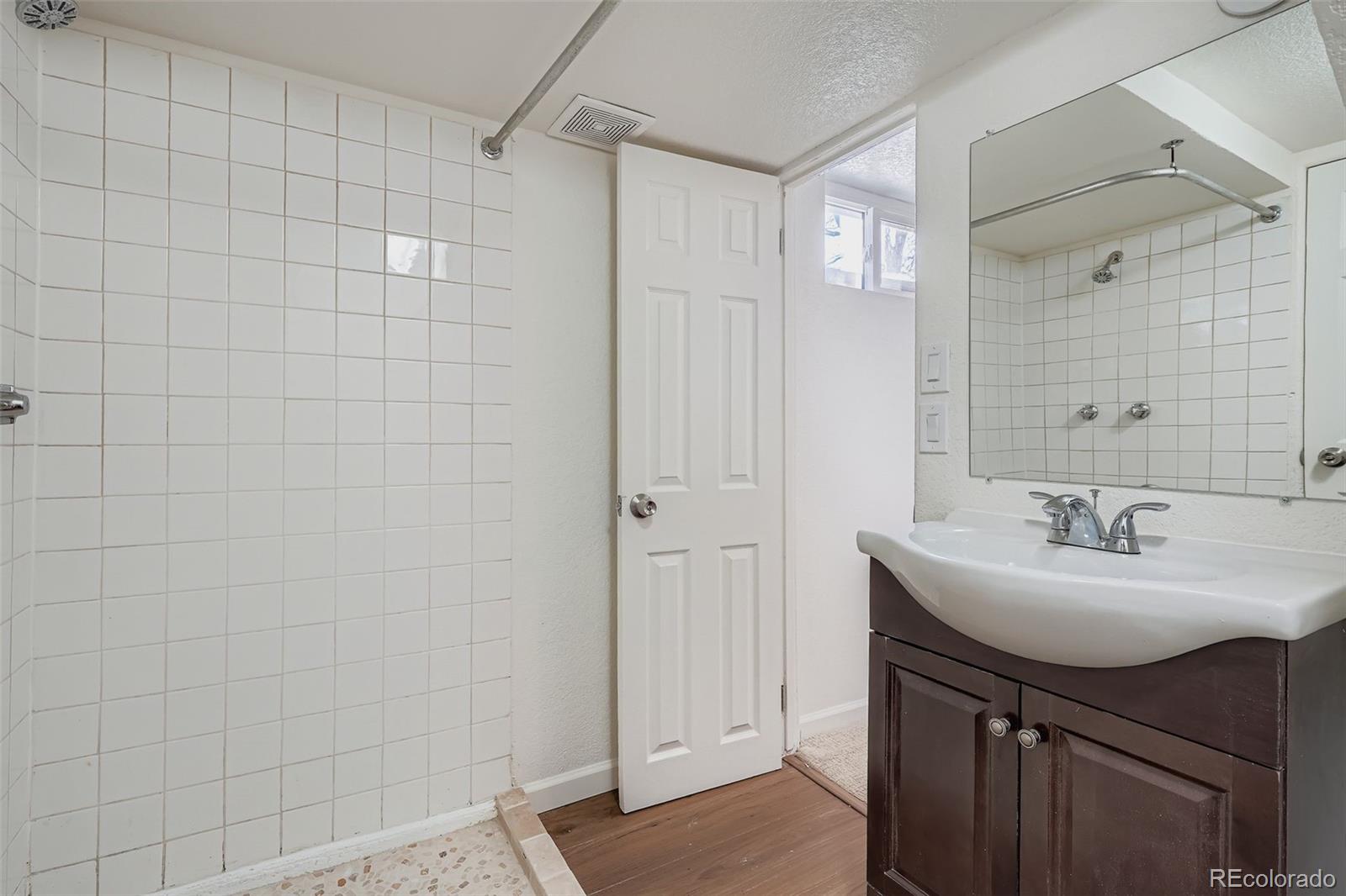 680 Irving Street Denver, CO 80204 - Photo 26 of 33 a bathroom with a sink a toilet and shower