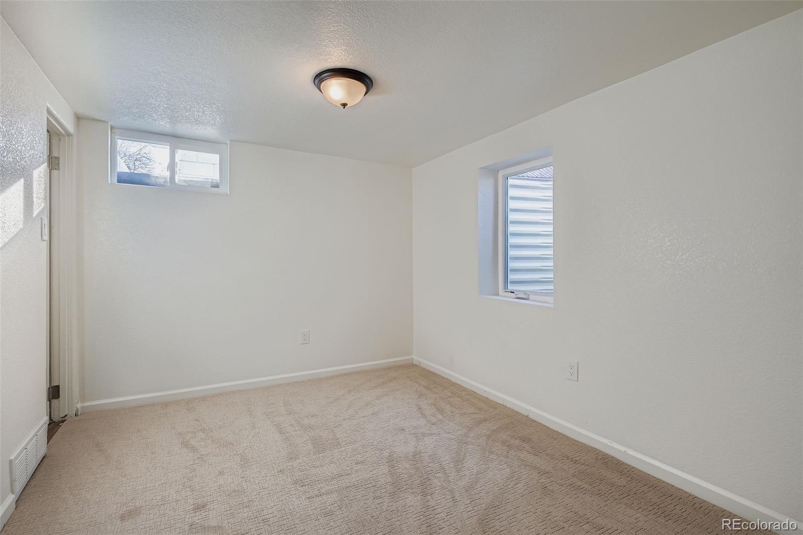 680 Irving Street Denver, CO 80204 - Photo 27 of 33 an empty room with windows